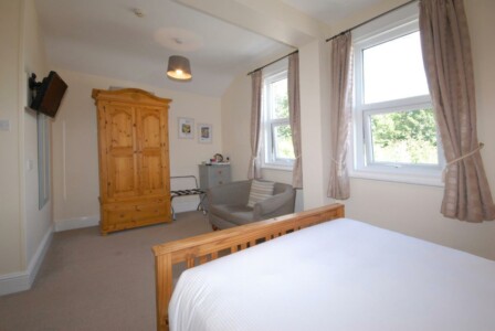 Large room with sofa for two.